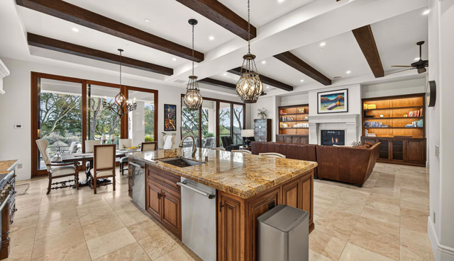 An open-concept floor plan and state-of-the-art efficiency is what high-end owners crave. The great room has an entertainer’s bar, cozy gas fireplace and hydralic hideaway TV.